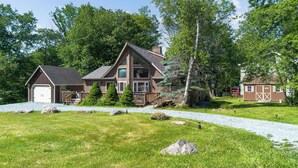 A two-story house with a large deck, a garage, and a small shed. - Bearitage Chalet Family Poconos Retreat in The Hideout Lake Pool Ski (The Hideout)