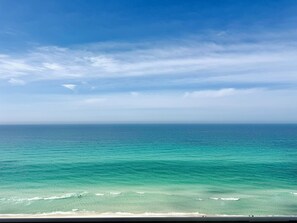 A beach with clear turquoise water and a view of the ocean. - Gulf-Front w/ Balcony Views & Family Comfort Free Golf & Activities Daily! (Panama City Beach)
