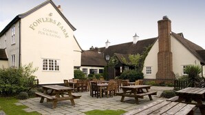 A traditional country pub with outdoor seating and a brick chimney. - Premier Inn Braintree (Braintree)