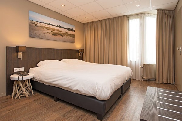 Relax into plush bedding in this warm, inviting double room.