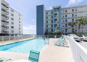 A hotel with a swimming pool, multiple balconies, and a parking area. - IS256-  Ahhhmazing View, Location X3, Pool, Beach Front, 2nd Floor! (Gulf Shores)