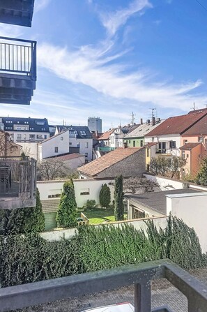 A residential area with houses, a clear sky, and a balcony.