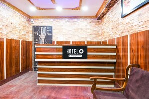 A reception desk with a sign reading 'HOTELO' and a wooden panel design. - Classic Wellbing (Bhubaneshwar)