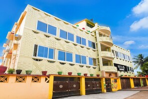 A multi-story hotel with a distinctive architectural design, featuring balconies and a prominent entrance. - Classic Wellbing (Bhubaneshwar)