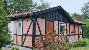 A two-story building with a brick facade, black trim, and a tiled roof. - 6 Person Holiday Home in Mellbystrand (Mellbystrand)