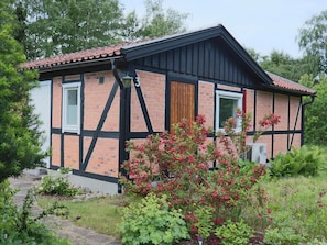 A two-story building with a brick facade, black trim, and a tiled roof. - 6 Person Holiday Home in Mellbystrand (Mellbystrand)