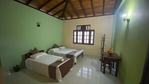 A room with two beds, a window, a chair, and a table. - GB Royal Stay Nuwara Wewa (Anuradhapuraya)