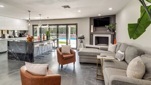 A modern living space with a kitchen, bar area, and seating area. - Vegas Getaway w/ Extra-deep Pool, 5 Mi to Strip! (Las Vegas)