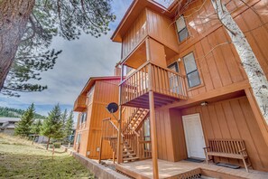 A multi-story wooden building with a balcony, a staircase, and a bench. - Walk to Angel Fire Resort! Mtn-view Condo Near Fun (Angel Fire)