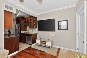 A modern kitchen with wooden cabinets, a built-in refrigerator, and a dishwasher.