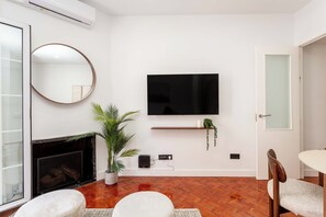 Interior - A classic two-bedroom in Chamberí with herringbone parquet and a floor-to-ceiling window onto the balcony, steps from Calle de Ponzano and the restaurants of Almagro. (MADRID)