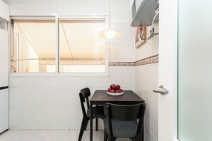 Dining - A classic two-bedroom in Chamberí with herringbone parquet and a floor-to-ceiling window onto the balcony, steps from Calle de Ponzano and the restaurants of Almagro. (MADRID)