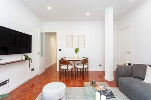 Living area - A classic two-bedroom in Chamberí with herringbone parquet and a floor-to-ceiling window onto the balcony, steps from Calle de Ponzano and the restaurants of Almagro. (MADRID)