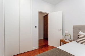 Room - A classic two-bedroom in Chamberí with herringbone parquet and a floor-to-ceiling window onto the balcony, steps from Calle de Ponzano and the restaurants of Almagro. (MADRID)