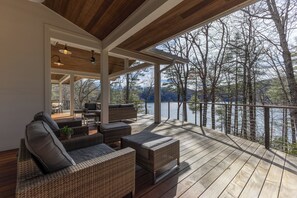 Terrace/patio - Lake access retreat on Lake Glenville with private dock with boat ties, kayaks, paddleboards, expansive deck, and fire pit seating. Sleeps 12 comfortably — designed for mountain air, lake days, and unforgettable nights under the stars. (Cullowhee)