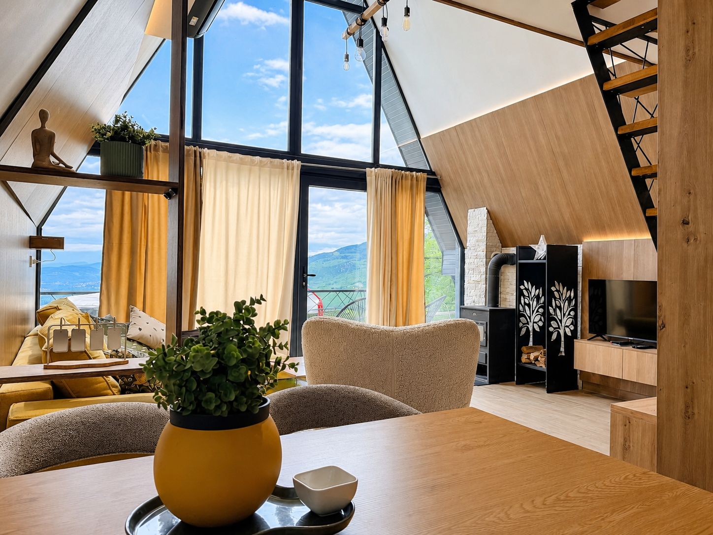 A modern interior with a large skylight, a cozy seating area, and a fireplace.