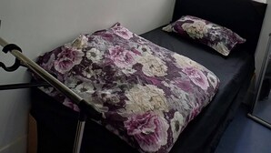 A bedroom with a bed, a wardrobe, a window, and a view of the outside. - Room-single Cosy Room Near CBS Arena and (Coventry)