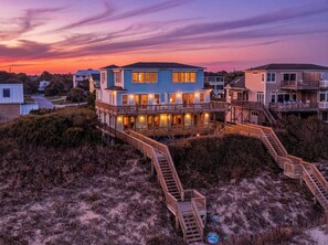 A beachfront property with a multi-level deck, wooden walkways, and a view of the ocean. - Thalasea, Oceanfront House in Emerald Isle, NC! (Emerald Isle)