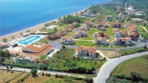 An aerial view of a coastal residential area with houses, a swimming pool, and a beach. - Serene studio with AC in lovely Lefkimmi Corfu (Lefkimmi Corfu)