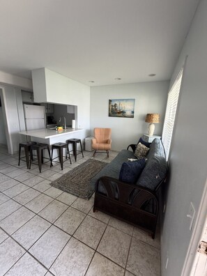 A modern living space with a kitchen, dining area, and seating area. - Sandcastle, Entertainment District (South Padre Island)