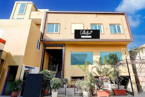 A modern building with a sign reading 'Collection' and 'Company-Serviced.'