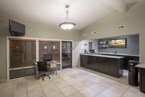 A modern kitchen with a large island, a built-in oven, and a flat-screen TV mounted above the counter. - Days Inn Provo (Provo)