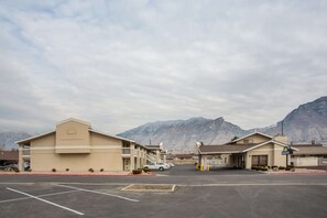 A Days Inn with a parking lot and mountainous backdrop. - Days Inn Provo (Provo)
