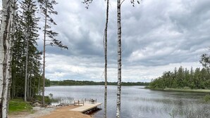 A lakeside view with a dock and birch trees. - 4 Star Holiday Home in Emmaboda (Emmaboda)