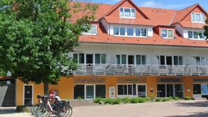 A two-story building with a red-tiled roof, a reception area, and a bicycle parking area. - 2 Person Holiday Park Home in Sassenburg (Sassenburg)
