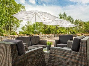 An outdoor seating area with wicker furniture and white umbrellas. - 2 Person Holiday Park Home in Feldberger Seenlandschaft (Feldberger Seenlandschaft)
