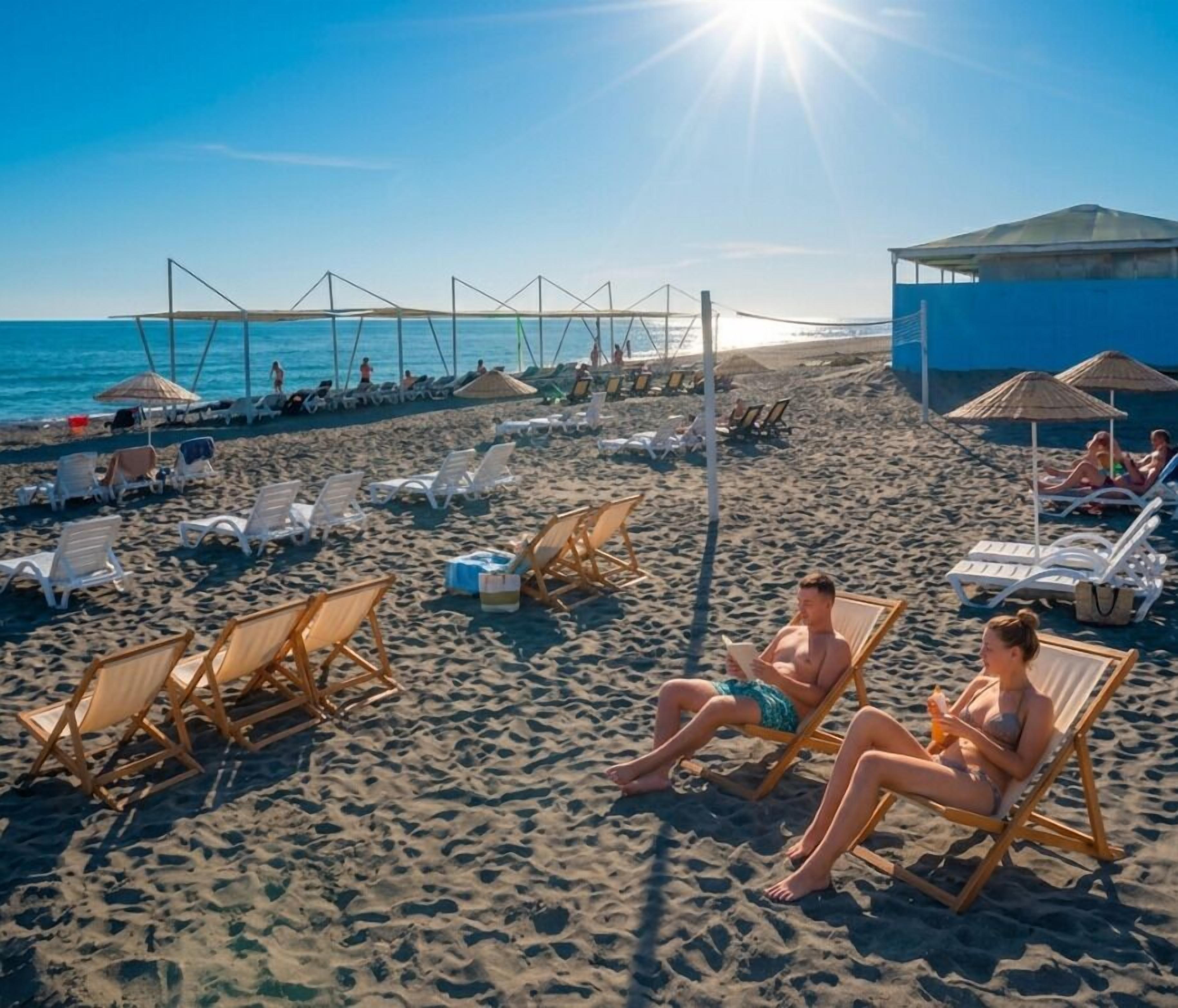 Private beach, black sand, sun loungers, beach umbrellas