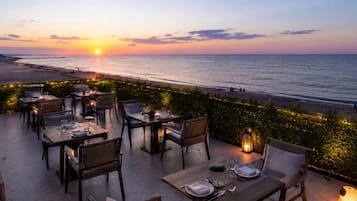 Private beach, black sand, sun loungers, beach umbrellas