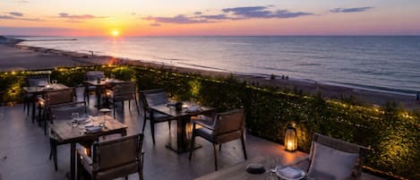 Private beach, black sand, sun loungers, beach umbrellas