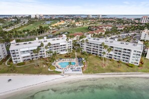 A resort with multiple buildings, a central pool, and a beach view. - Coastal Getaway | Bahia Vista | Ground Floor BV8-115 (Isla Del Sol)