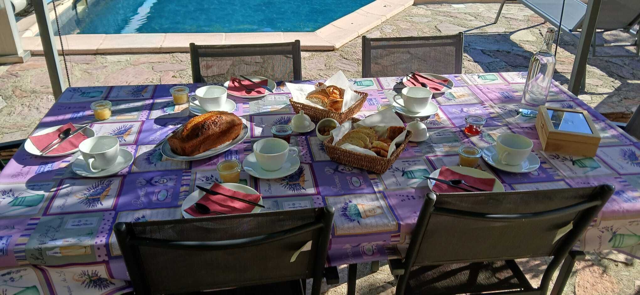 A table set outdoors with a pool in the background.