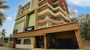 A multi-story building with a sign indicating 'Townhouse' and 'Company Serviced.' - Classic Madgaon (Margao)