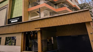 A multi-story building with a sign reading 'TOWNHOUSE & Company-Serviced.' - Classic Madgaon (Margao)