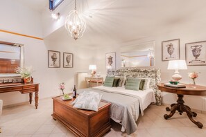 A bedroom with a bed, bedside tables, a dresser, a desk, and a chandelier. - Villa Near Lucca With Vineyard Views (Lucca)