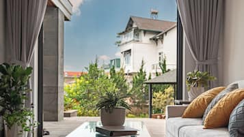 Deluxe Apartment, Garden View | Living area | 43-inch Smart TV with digital channels