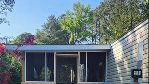 A small wooden structure with a door, a fenced area, and a gravel path leading to it. - Terrific 2-bedroom mobile home,  perfect for bringing your boat (Wilmington)