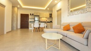 Una sala moderna con sofá, una mesa de centro y un comedor con sillas.