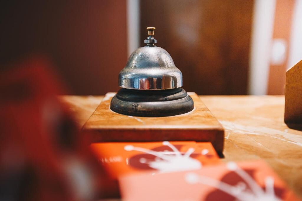 A metallic object on a wooden surface, possibly a bell or a decorative item.