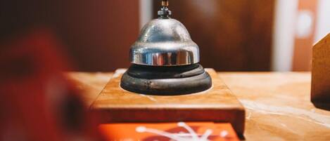 A metallic object on a wooden surface, possibly a bell or a decorative item.