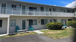 A two-story motel with a balcony on the upper floor, a small front yard, and a number 441 sign. - Updated 1BR Across from Ocean – Prime Deerfield Beach Location (Deerfield Beach)