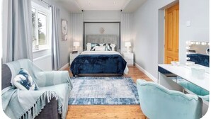 A bedroom with a bed, bedside tables, a desk, a chair, and a window with curtains. - Large detached home for families and group stays (Hoyland)