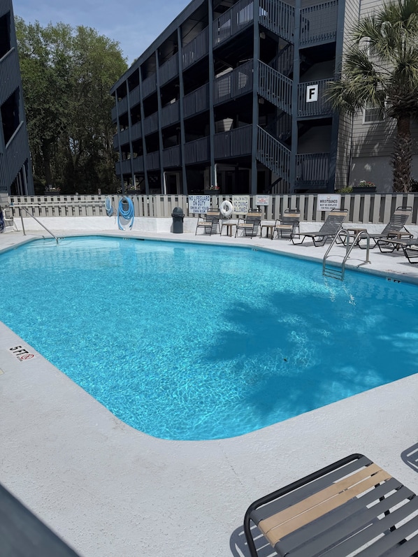 A swimming pool with lounge chairs, a lifeguard stand, and a no diving sign. -  Scenic Golf Course View Retreat - UPDATED 2BR Condo-Close to Beach (North Myrtle Beach)