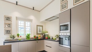 A modern kitchen with a built-in oven, a sink, and a window. - Charming Lucca Villa With Garden (Lucca)