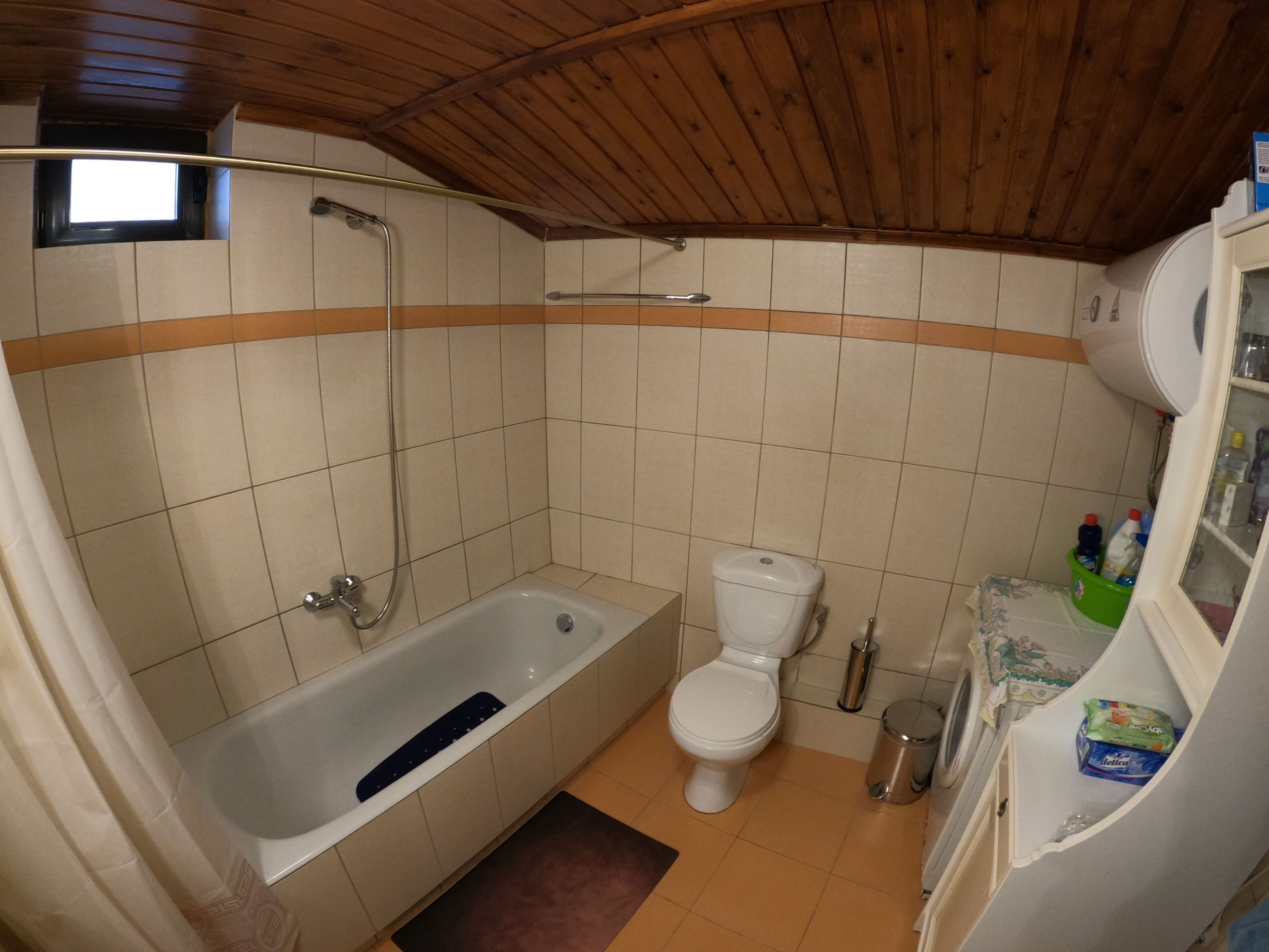 A bathroom with a bathtub, toilet, and a shower.