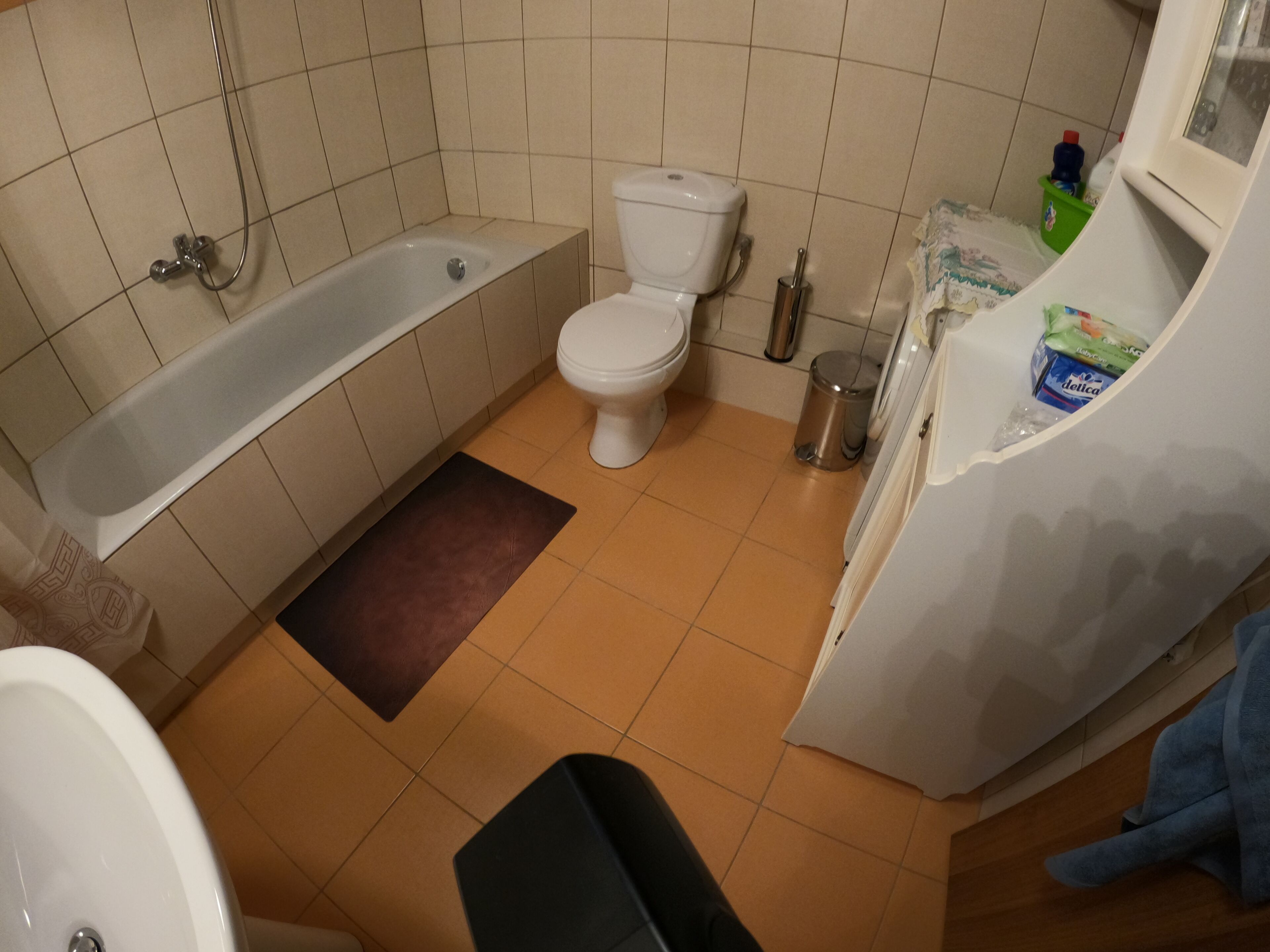 A bathroom with a bathtub, toilet, and sink.