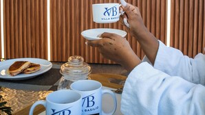 A wooden sign with 'Villa Basilio' branding, a tray with two branded mugs, a plate with food, and a jar. - Villabasiliord Spacious house, quiet and safe place, 5 mins from the beach. (Puerto plata)